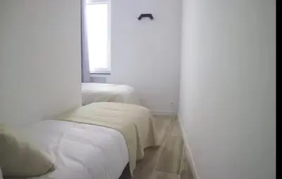 a white room with a bed and a window at Urban Cityflats - Center Antwerp in Antwerp