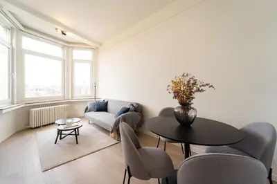 a living room with a table and a couch at Urban Cityflats - Center Antwerp in Antwerp