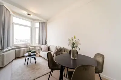 a living room with a couch and a table with chairs at Urban Cityflats - Center Antwerp in Antwerp