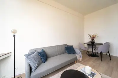 a living room with a couch and a table at Urban Cityflats - Center Antwerp in Antwerp