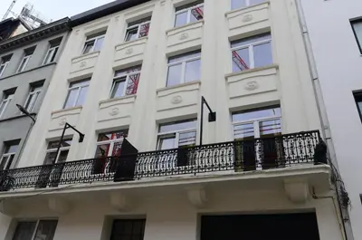 a large white building with a balcony at SLEEP INN - Palace Apartments - 2 Bedrooms in Antwerp