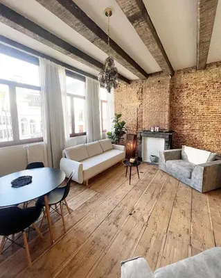 a living room with a couch and a table at LouLou Home's in Antwerp