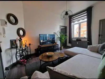 a living room with a couch and a table at Ailes Center 3 in Brussels