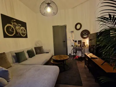 a living room with a couch and a bike on the wall at Ailes Center 3 in Brussels