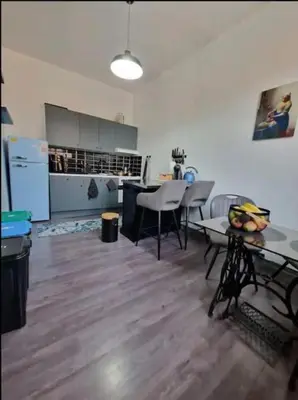 a kitchen and dining room with a table and chairs at Ailes Center 3 in Brussels