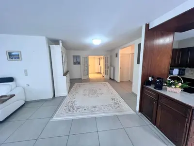 a kitchen and living room with a rug on the floor at Windsor Residence Grimbergen in Grimbergen