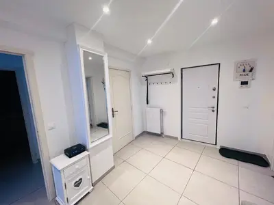 a white room with a door and a mirror at Windsor Residence Grimbergen in Grimbergen