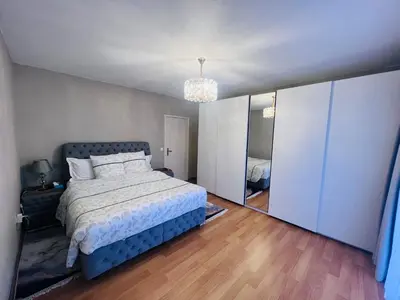 a bedroom with a bed and a large mirror at Windsor Residence Grimbergen in Grimbergen