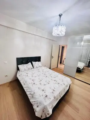 a bedroom with a bed and a chandelier at Windsor Residence Grimbergen in Grimbergen