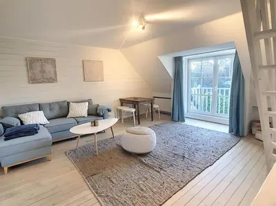 a living room with a couch and a table at Cottage en bordure bruxelloise in Wezembeek-Oppem