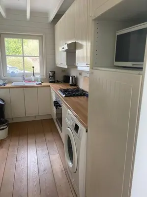 a kitchen with a washer and dryer in it at Cottage en bordure bruxelloise in Wezembeek-Oppem