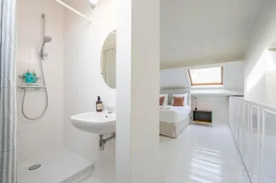 a white bathroom with a bed and a sink at SHWAY - The Handshake House in Antwerp