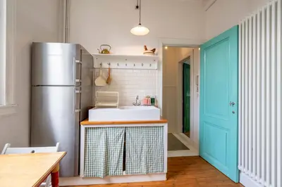 a kitchen with a sink and a refrigerator at SHWAY - The Handshake House in Antwerp