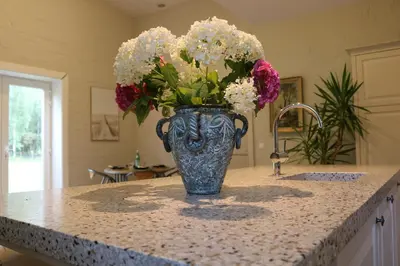 a vase filled with flowers sitting on top of a counter at Rustiek vakantiehuis in 't groen in Lier