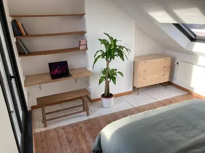a bedroom with a bed and a potted plant at Gezellig gerenoveerd herenhuis in het centrum in Antwerp
