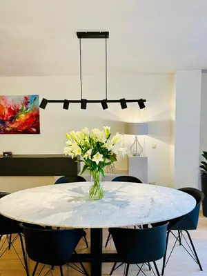a dining room table with a vase of flowers on it at Urbanstay Suites Grand Place Luxury Apartment in Brussels