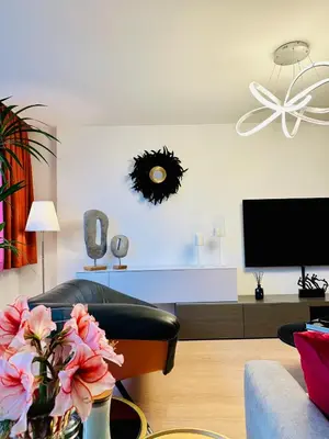 a living room with a chair and a tv at Urbanstay Suites Grand Place Luxury Apartment in Brussels