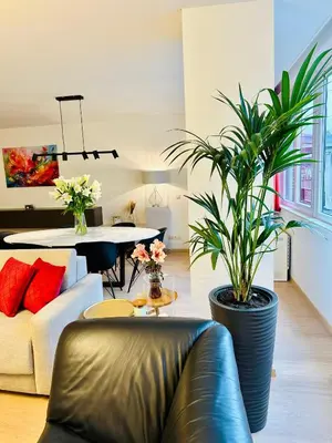 a living room with a couch and a table with plants at Urbanstay Suites Grand Place Luxury Apartment in Brussels