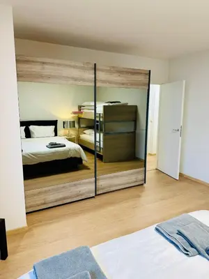 a bedroom with a mirrored wall with two beds at Urbanstay Suites Grand Place Luxury Apartment in Brussels