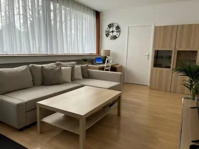 a living room with a couch and a coffee table at Appartement Brussels Expo Atomium in Grimbergen