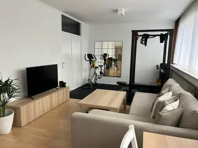a living room with a couch and a flat screen tv at Appartement Brussels Expo Atomium in Grimbergen