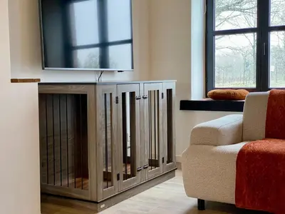 a living room with a tv and a couch and a chair at Lindehoeve in Turnhout