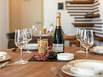 a bottle of wine sitting on a table with glasses at Lindehoeve in Turnhout