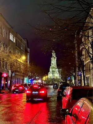 a busy city street at night with cars on the road at Luxury Suites Museum by Rikas Hotels in Antwerp