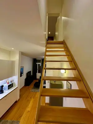 a staircase leading up to a living room at Luxury Suites Museum by Rikas Hotels in Antwerp