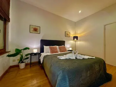 a bedroom with a bed with towels on it at Luxury Suites Museum by Rikas Hotels in Antwerp