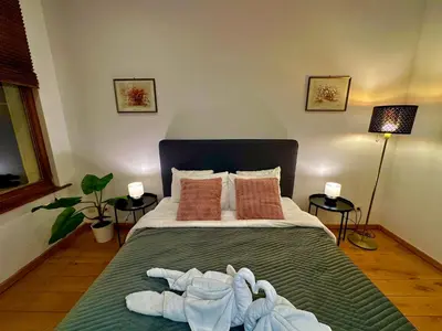 a bedroom with a bed with towels on it at Luxury Suites Museum by Rikas Hotels in Antwerp