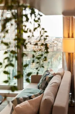 a couch in a living room with a large window at The Wonder Shore in Antwerp
