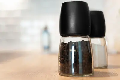 two glass bottles with black caps sitting on a table at The Wonder Shore in Antwerp