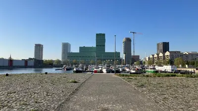 a marina with boats in the water and buildings at The Wonder Shore in Antwerp