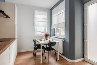 a dining room with a white table and chairs at Evere EU Residence in Brussels