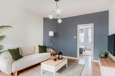 a living room with a couch and a tv at Evere EU Residence in Brussels