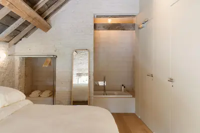 a bedroom with a bed and a bath tub at Hopspot in Evergem