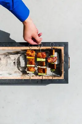 a person is cooking food on a grill at Hopspot in Evergem