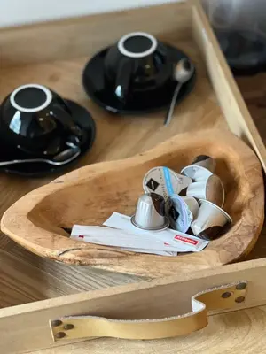 a wooden tray with cups and dishes in a drawer at Elinoa in Machelen
