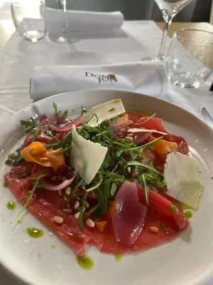 a white plate with a salad on a table at Elinoa in Machelen