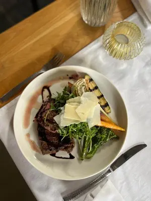 a white plate of food on a table at Elinoa in Machelen