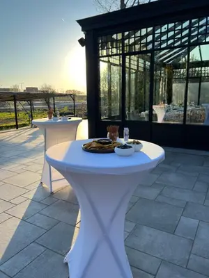a white table sitting on top of a patio at Elinoa in Machelen