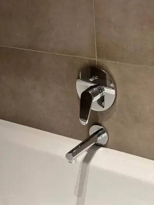 a faucet on a wall in a bathroom at Elinoa in Machelen