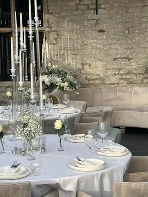 a table with white table cloths and candles on it at Elinoa in Machelen