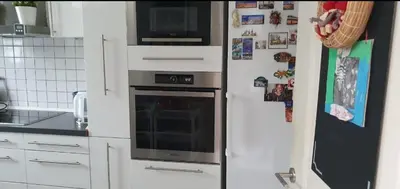 a kitchen with a stove and a refrigerator at COSY HOUSE 6BEDROOMS GARDEN in Mortsel