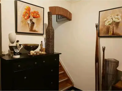 a room with a dresser with a vase on it at COSY HOUSE 6BEDROOMS GARDEN in Mortsel