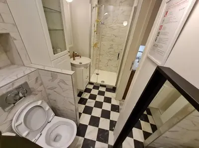 a small bathroom with a toilet and a sink at Studio chaleureux & moderne, région bruxelloise in Asse