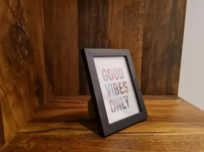 a picture frame with a good vibes only sign on a table at Studio chaleureux & moderne, région bruxelloise in Asse