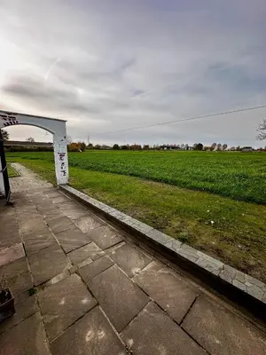 a white bridge over a field with a green field at White House in Ternat