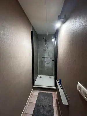 a bathroom with a shower with a glass door at White House in Ternat